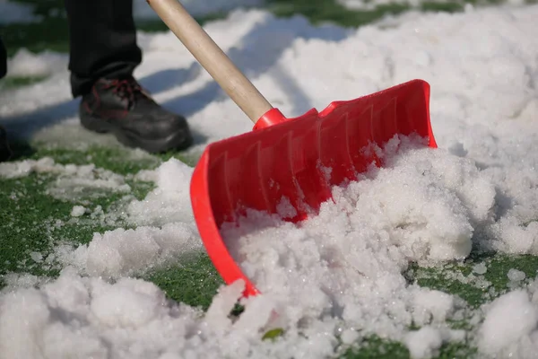 stock image men using Red blurry snow shovel