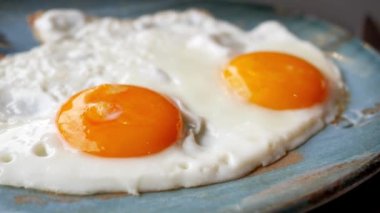 Fried eggs in the plate close up ,,