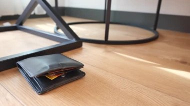  left wallet on floor at home .