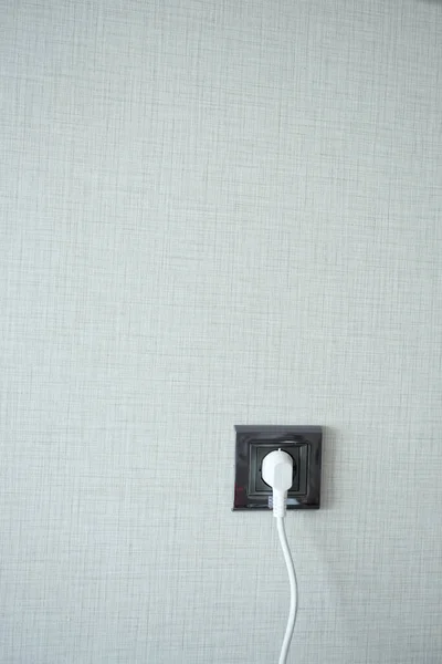 stock image  white color power cord cable plugged into wall .