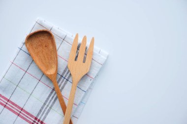  wooden cutlery fork and spoon on a chopping board on table ,