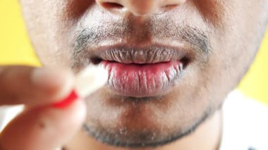 young men taking medical pill .