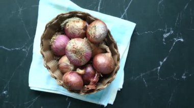 red onion in a bowl on table .