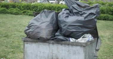 Bag with garbage and rubbish bin,