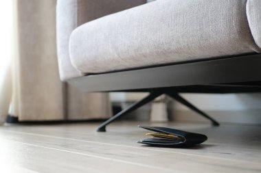  left wallet on floor at home .