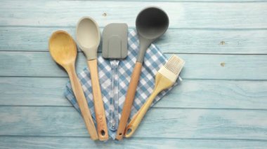  wooden cutlery fork and spoon on a chopping board on table ,