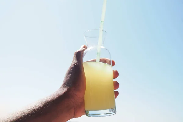 stock image holding a glass of orange juice close up ,