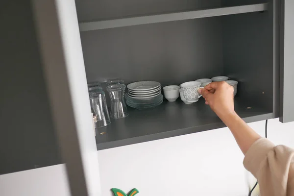 Женщины Открывают Кухонный Шкаф — стоковое фото