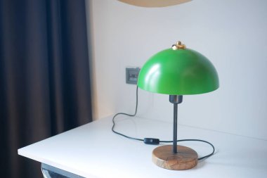 a lamp in home against white wall .