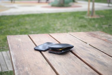  left wallet on a bench in the park ,