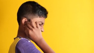 teenage boy having ear pain touching his painful ear 
