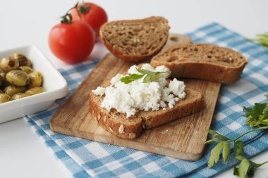 fresh paneer on a bread on table .