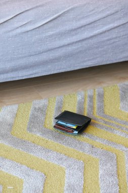  left wallet on floor at home .