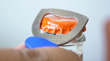 Cam şişede metal kapak ve açacağı var.. 