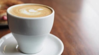 Kafenin tepesinde çiçek desenli geç kalmış bir fincan kahve. .