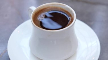 top view of hot coffee with bubble on white background ,