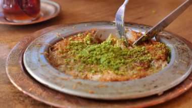 kunafa with a wipe cream on a plate