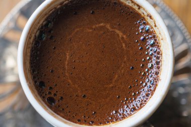 top view of hot coffee with bubble on white background ,