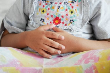  child suffering stomach pain close up..