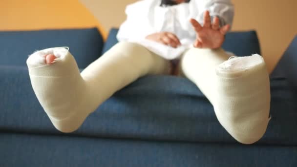 足に石膏の包帯をした小さな子供の男の子 — ストック動画
