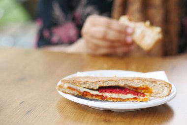 Kadınlar, jambonlu, peynirli, domatesli sandviç seçer.,