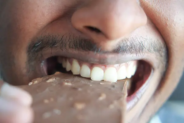 Young Man Eating Dark Chocolate Close — Stock Photo, Image
