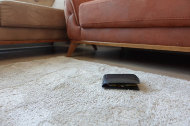  left wallet on floor at home .
