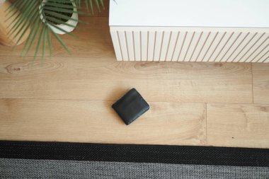  left wallet on floor at home .