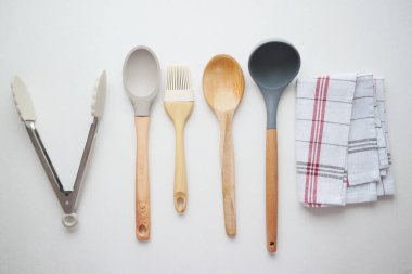  wooden cutlery fork and spoon on a chopping board on table ,