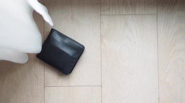  left wallet on floor at home .