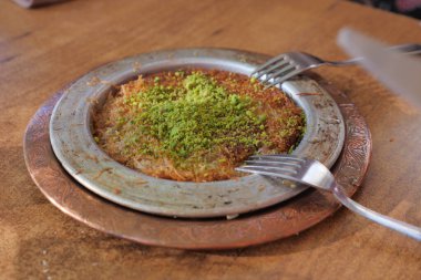 kunafa with a wipe cream on a plate