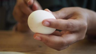 women hand perfectly Peeled Boiled Eggs .