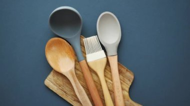  wooden cutlery fork and spoon on a chopping board on table ,
