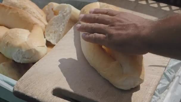 在街上的切碎板上切长面包的慢动作 — 图库视频影像