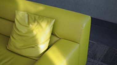 yellow color modern sofa with pillows in living room at home,