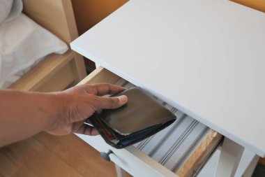 men stealing wallet from a drawer ,
