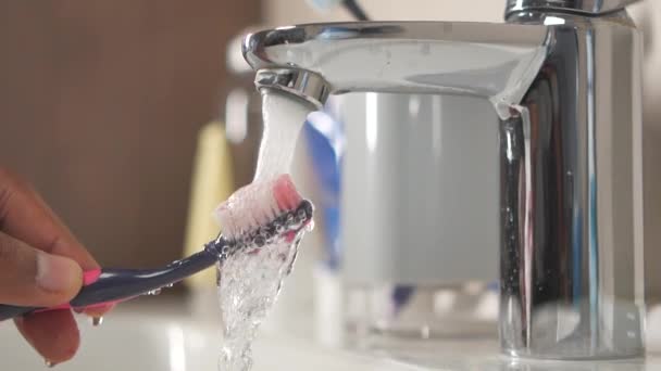 Slow Motion Holding Toothbrush Flowing Water Bathroom Closeup — Stock Video