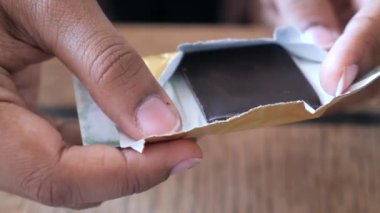 removing packet from a chocolate .