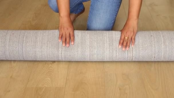 Woman Rolling Out New Rug — Stock Video