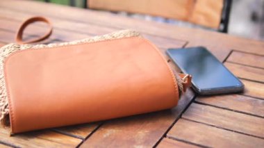 Kadın cüzdanı ve kafe masasında akıllı bir telefon. .