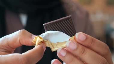 removing packet from a chocolate .