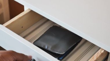 men stealing wallet from a drawer ,