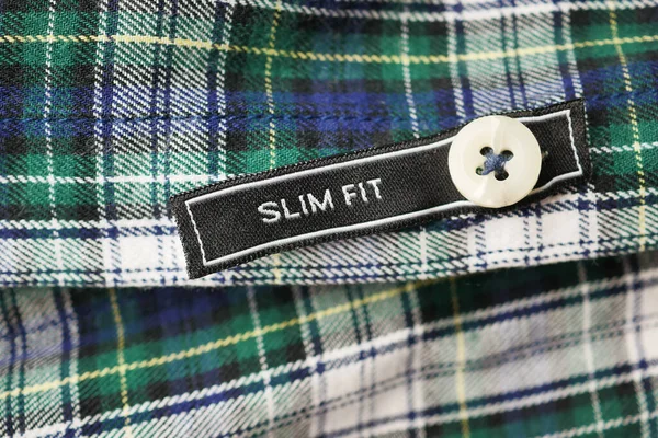 label tag slim fit on a men shirt .