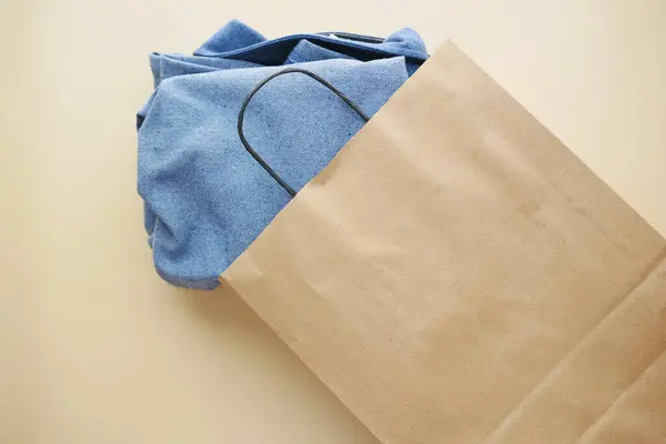 top view of craft paper bag with shirt