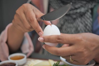 women hand perfectly Peeled Boiled Eggs .