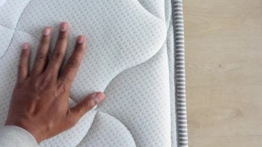 Yatağın üzerine elinle ortopedik yatak dokundur ve bastır.