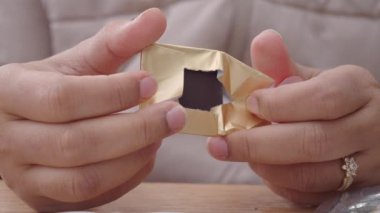 removing packet from a chocolate .