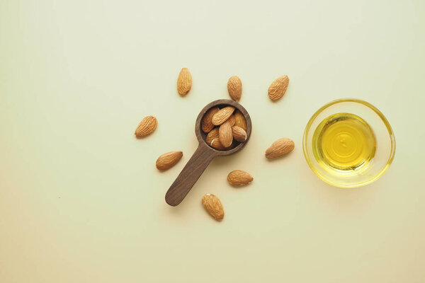 almond oils and fresh nuts on table ,