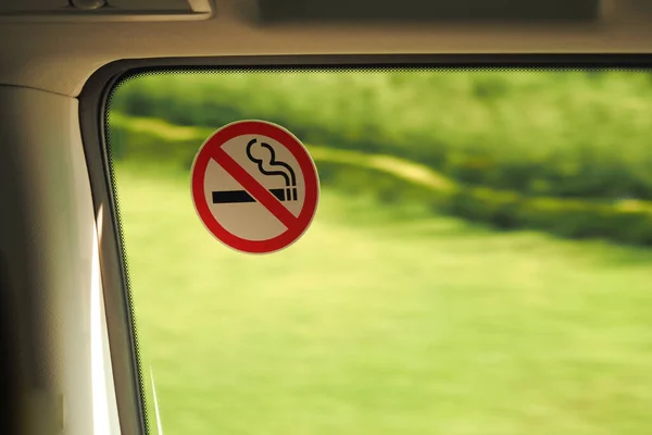No smoke sign on car window .