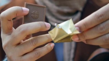 removing packet from a chocolate .